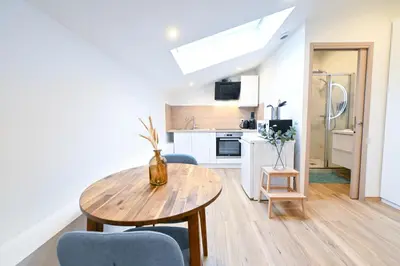 a kitchen and dining room with a table and chairs at Beau studio cozy centre ville et plages n13 in Nice