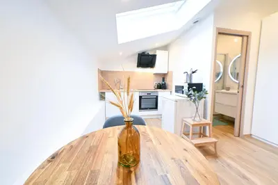 a vase on a wooden table in a kitchen at Beau studio cozy centre ville et plages n13 in Nice
