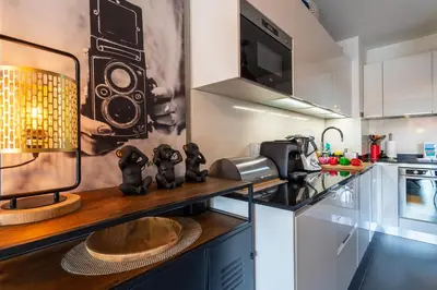 a kitchen with a counter with a speaker on the wall at DOMAINE DES ROSES 3 AP4400 By Riviera Holiday Home in Nice
