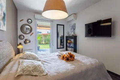 a bedroom with a bed with a pumpkin on it at DOMAINE DES ROSES 3 AP4400 By Riviera Holiday Home in Nice