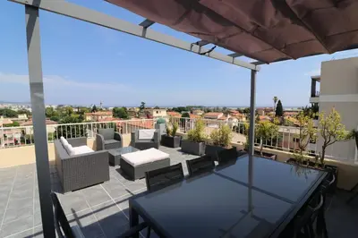 a bedroom with a bed in a small room at Superbe appartement toit Terasse vue mer in Saint-Laurent-du-Var