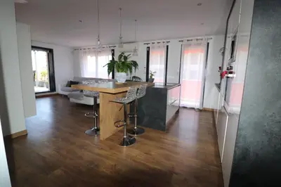 a kitchen with a island in the middle of a room at Superbe appartement toit Terasse vue mer in Saint-Laurent-du-Var