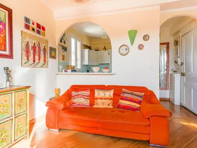 an orange couch sitting in a living room at Apartment L'Île de Beauté by Interhome in Nice