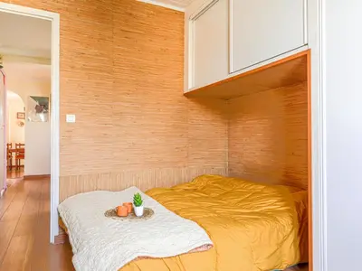 a bedroom with a bed with a wooden wall at Apartment L'Île de Beauté by Interhome in Nice