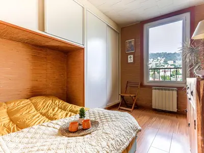 a bedroom with a bed and a large window at Apartment L'Île de Beauté by Interhome in Nice