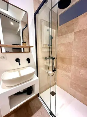 a bathroom with a sink and a glass shower at Rue Droite - Studio cosy au coeur du Vieux-Nice in Nice