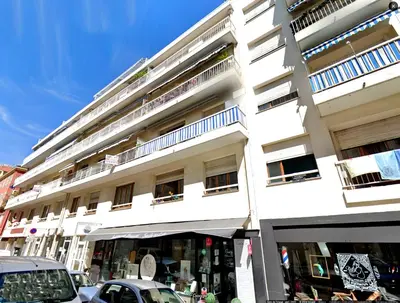 a table with chairs and potted plants on a balcony at Sunny apartment Garibaldi Port, FREE Private parking in Nice