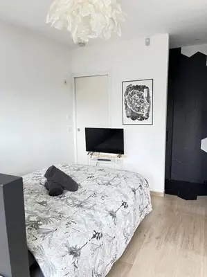 a bedroom with a bed and a flat screen tv at AmorePP Studio design près Stade Allianz Riviera in Nice
