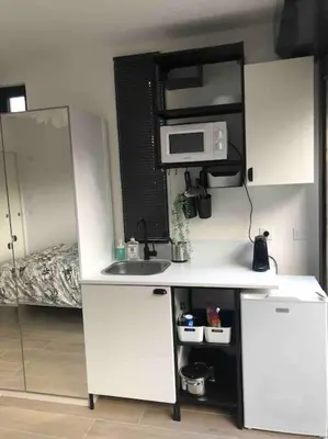 a small kitchen with a sink and a microwave at AmorePP Studio design près Stade Allianz Riviera in Nice