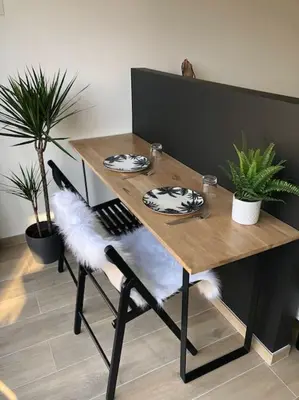 a wooden table with two plates on top of it at AmorePP Studio design près Stade Allianz Riviera in Nice