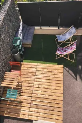 an overhead view of a patio with chairs and a couch at AmorePP Studio design près Stade Allianz Riviera in Nice