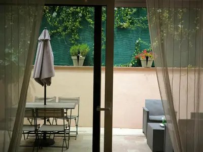 a table and chairs with an umbrella on a patio at Beau studio cozy centre ville et plages avec terrasse n3 in Nice