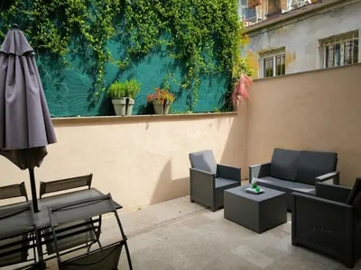 a patio with chairs and a table and an umbrella at Beau studio cozy centre ville et plages avec terrasse n3 in Nice