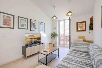 a living room with a couch and a flat screen tv at Maison Bianchi - 27 Lepante in Nice