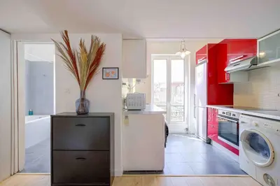 a kitchen with red cabinets and a white refrigerator at Maison Bianchi - 27 Lepante in Nice