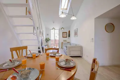 a dining room with a table and chairs and a couch at Maison Bianchi - 27 Lepante in Nice