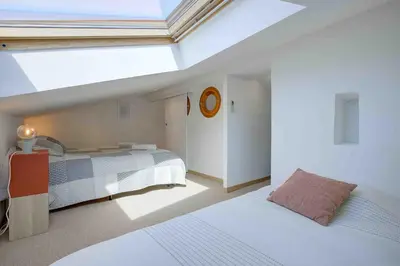 a bedroom with two beds and a skylight at Maison Bianchi - 27 Lepante in Nice