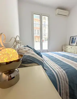 a bedroom with a bed and a bowl on a table at Les Terrasses D'Herold in Nice