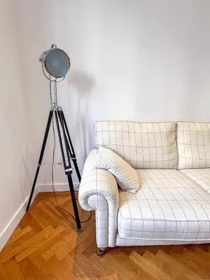 a lamp and a white couch in a living room at Les Terrasses D'Herold in Nice