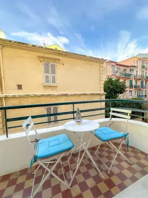 a table and two chairs on a balcony at Les Terrasses D'Herold in Nice