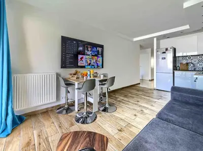 a kitchen and living room with a table and chairs at 1 min to beach bedroom flat with 2 AC and parking in summer in Nice
