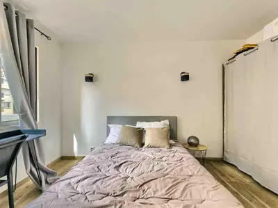 a bedroom with a large bed in a room at 1 min to beach bedroom flat with 2 AC and parking in summer in Nice