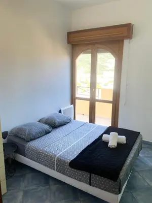 a bedroom with a bed with two towels on it at APPARTEMENT-NICE 01 VUE MER - PANORAMIQUE WIFI-Parking in Nice