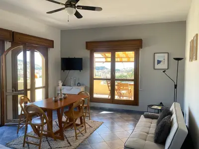 a living room with a table and a couch at APPARTEMENT-NICE 01 VUE MER - PANORAMIQUE WIFI-Parking in Nice