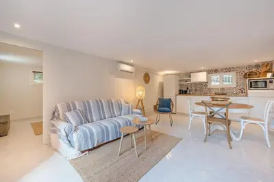 a living room with a couch and a table at Charmant 2 pièces au cœur de St Jean Cap Ferrat in Saint-Jean-Cap-Ferrat