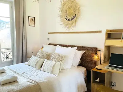 a bedroom with a bed with a laptop on a desk at Le Garib in Nice