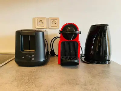 a counter with two toasters and a toaster and a blender at Le Garib in Nice