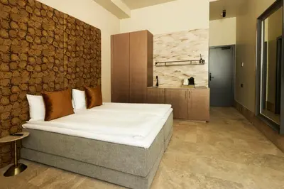 a bedroom with a bed and a brick wall at EZE BEACH Residence in Èze