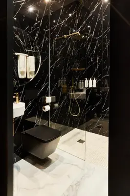 a bathroom with a shower with a hose on the wall at EZE BEACH Residence in Èze