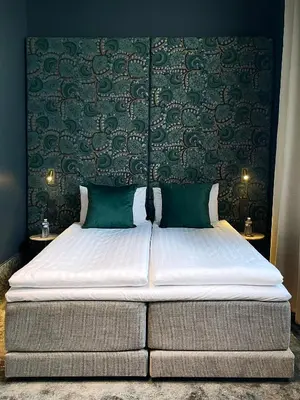 a large bed in a bedroom with green walls at EZE BEACH Residence in Èze