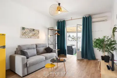 a living room with a couch and a table at Studio Californie FSHH in Nice