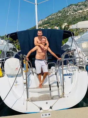 two men standing on a boat in the water at 5 mn du centre de Beaulieu. in Beaulieu-sur-Mer