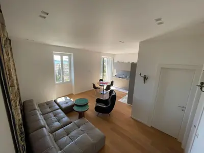 a living room with a couch and a table at 5 mn du centre de Beaulieu. in Beaulieu-sur-Mer