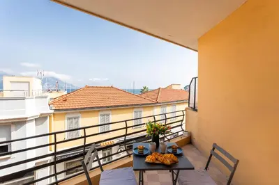 a table and chairs on a balcony with a view at Cap Ferrat View III AP4401 By Riviera Holiday Hom in Saint-Jean-Cap-Ferrat