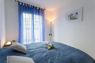 a teddy bear sitting on top of a blue bed at PALAIS DES ARTS AP4399 By Riviera holiday homes in Nice