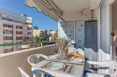 a table and chairs on a balcony with a view of a building at PALAIS DES ARTS AP4399 By Riviera holiday homes in Nice
