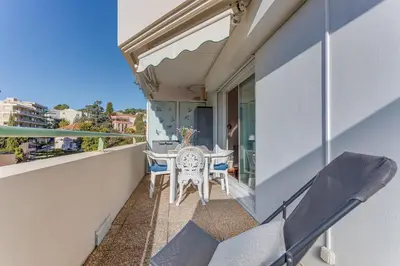 a balcony with a table and chairs on a building at PALAIS DES ARTS AP4399 By Riviera holiday homes in Nice