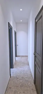 an empty hallway with two doors and a tile floor at Maison Bianchi - Hôtel des Postes in Nice
