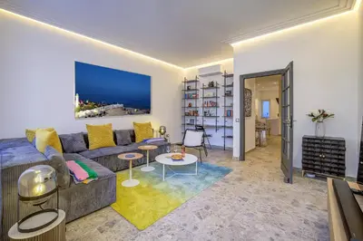 a living room with a couch and a table at Maison Bianchi - Hôtel des Postes in Nice