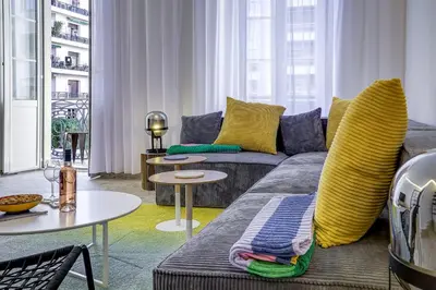 a living room with a couch and a table at Maison Bianchi - Hôtel des Postes in Nice