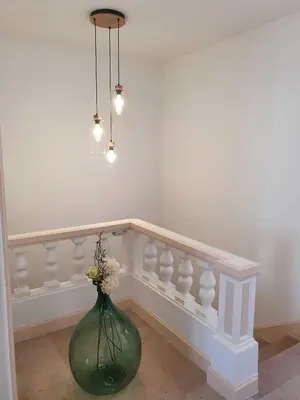 a green vase with flowers in a room at Villa kriss in Nice