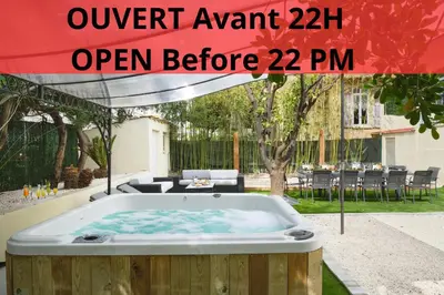 a hot tub in a yard with a table and chairs at VILLA DES PERGOLAS -6 Bdrs - 5 bathrs -Parking -Jardin -JACUZZI -TRAMstation , 10 min beach in Nice