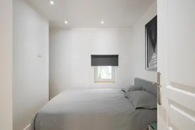 a white bedroom with a bed and a window at VILLA DES PERGOLAS -6 Bdrs - 5 bathrs -Parking -Jardin -JACUZZI -TRAMstation , 10 min beach in Nice