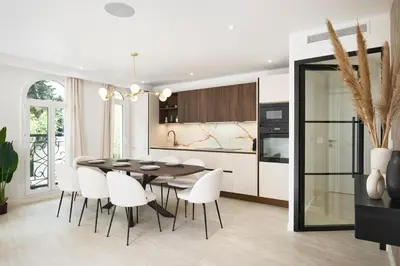 a kitchen and dining room with a table and chairs at VILLA DES PERGOLAS -6 Bdrs - 5 bathrs -Parking -Jardin -JACUZZI -TRAMstation , 10 min beach in Nice