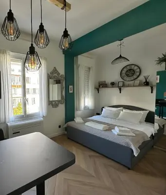 a bedroom with a large bed with green walls at Paradise Studio - Hyper Centre in Nice