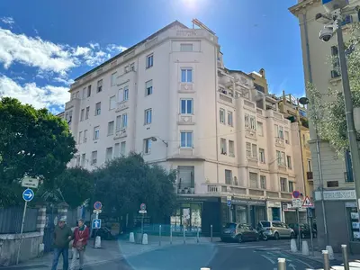 a building on a street with two people walking in front at Paradise Studio - Hyper Centre in Nice
